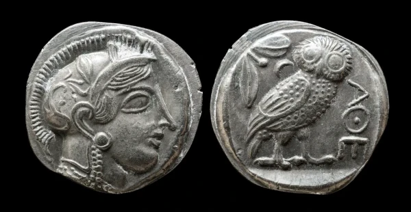 An ancient silver Athenian owl tetradrachm showing the obverse profile of the goddess Athena and the reverse owl symbol, illustrating classical Greek numismatic history in our history of coins guide